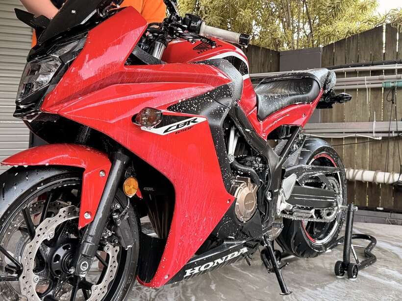Finlay's red Honda CBR650F freshly washed, water beading on the fairings