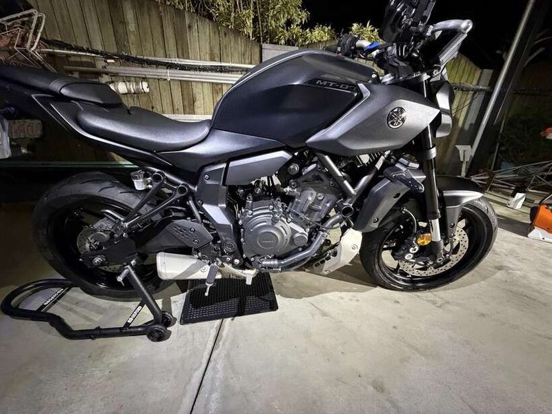 Grey Yamaha MT-07 on a paddock stand, detailed at night