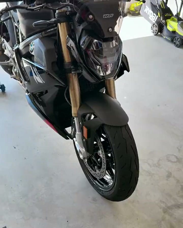 BMW S1000R after paint correction and a ceramic coating — front-on, then the cleaned engine cases and exhaust