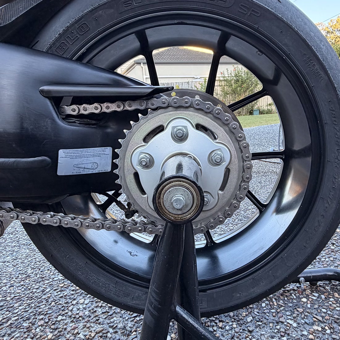 The same Ducati 848 chain after a Fins detail — spotless links and a polished sprocket