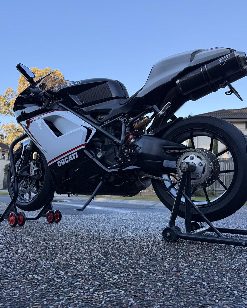 Ducati 848 EVO on paddock stands at dusk after a full detail