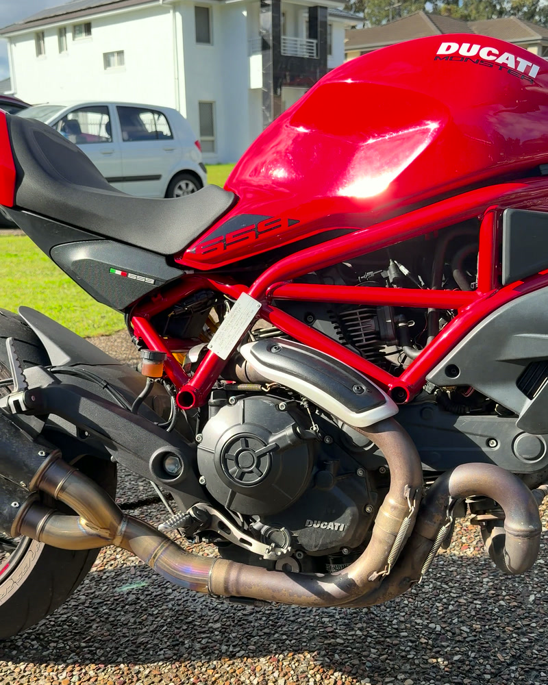 Ducati Monster 659 after detailing — red trellis frame and polished exhaust headers