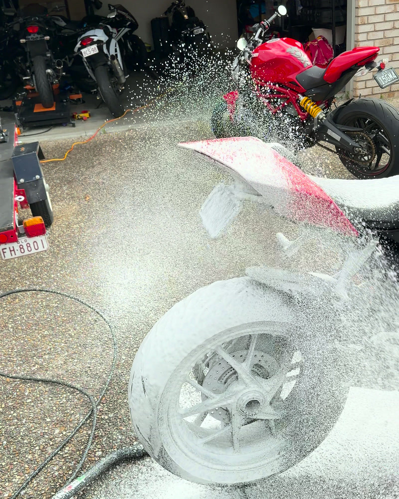Foam rinsing off a Ducati wheel under the pressure washer